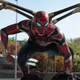 Spider-Man, in his multi-armed red and gold Iron Spider suit, crouches in readiness on a freeway.